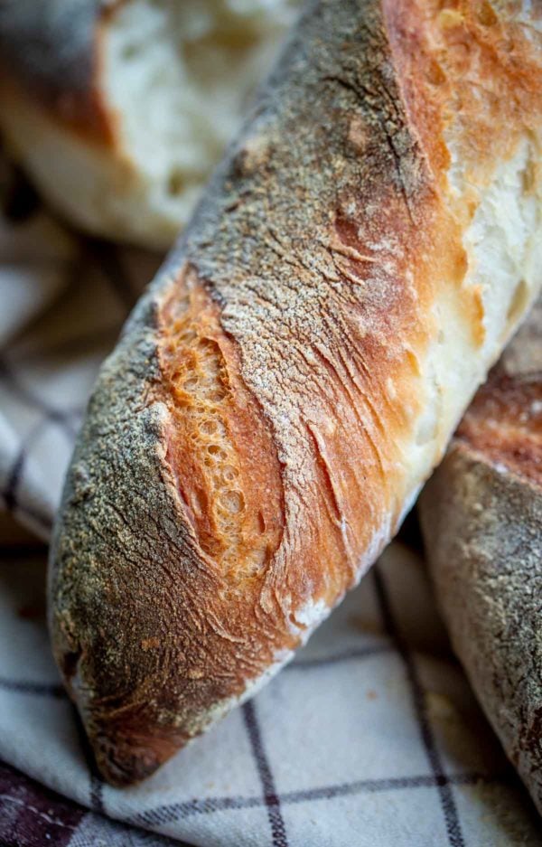 Baguette close up with floured and crisped up exterior.