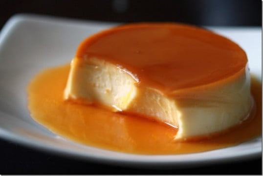 The best flan recipe in a plate with a spoonful missing. 