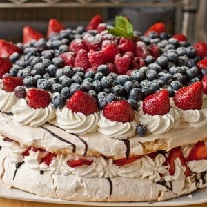 Boccone Dolce - light airy meringue cake topped with chocolate drizzle, Chantilly Cream & Berries. by @Letthebakingbegin