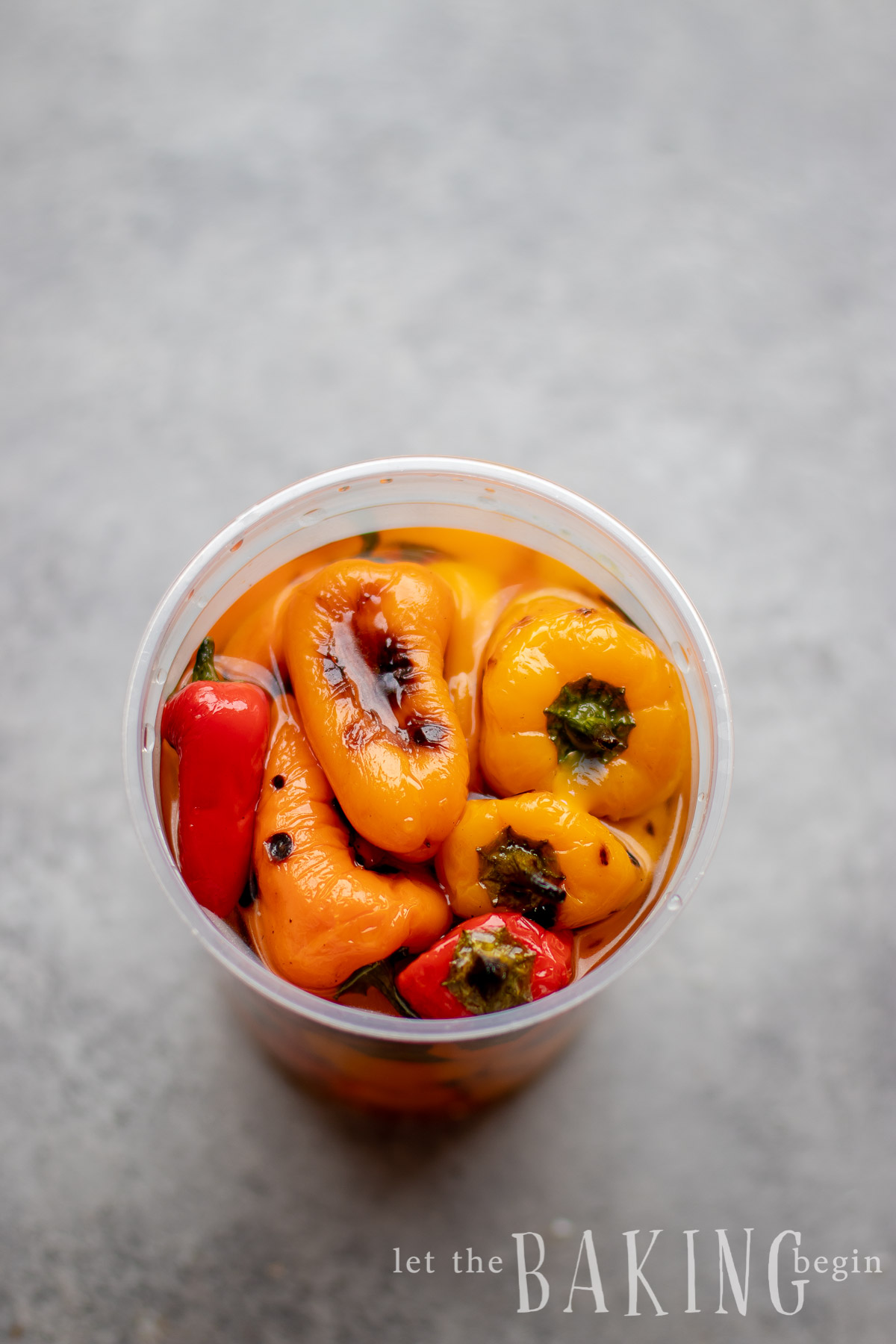 Mini bell peppers in a plastic container.