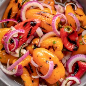 Pickled Mini Bell Peppers are oven roasted or grilled then marinated in a sweet tangy marinade, and finally combined with sweet onions for a great appetizer or a side dish. 