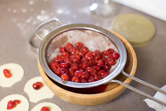 How to drain cherries with a strainer.
