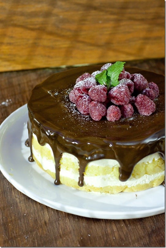 Bostin cream pie cake topped with chocolate ganache with fresh raspberries. 