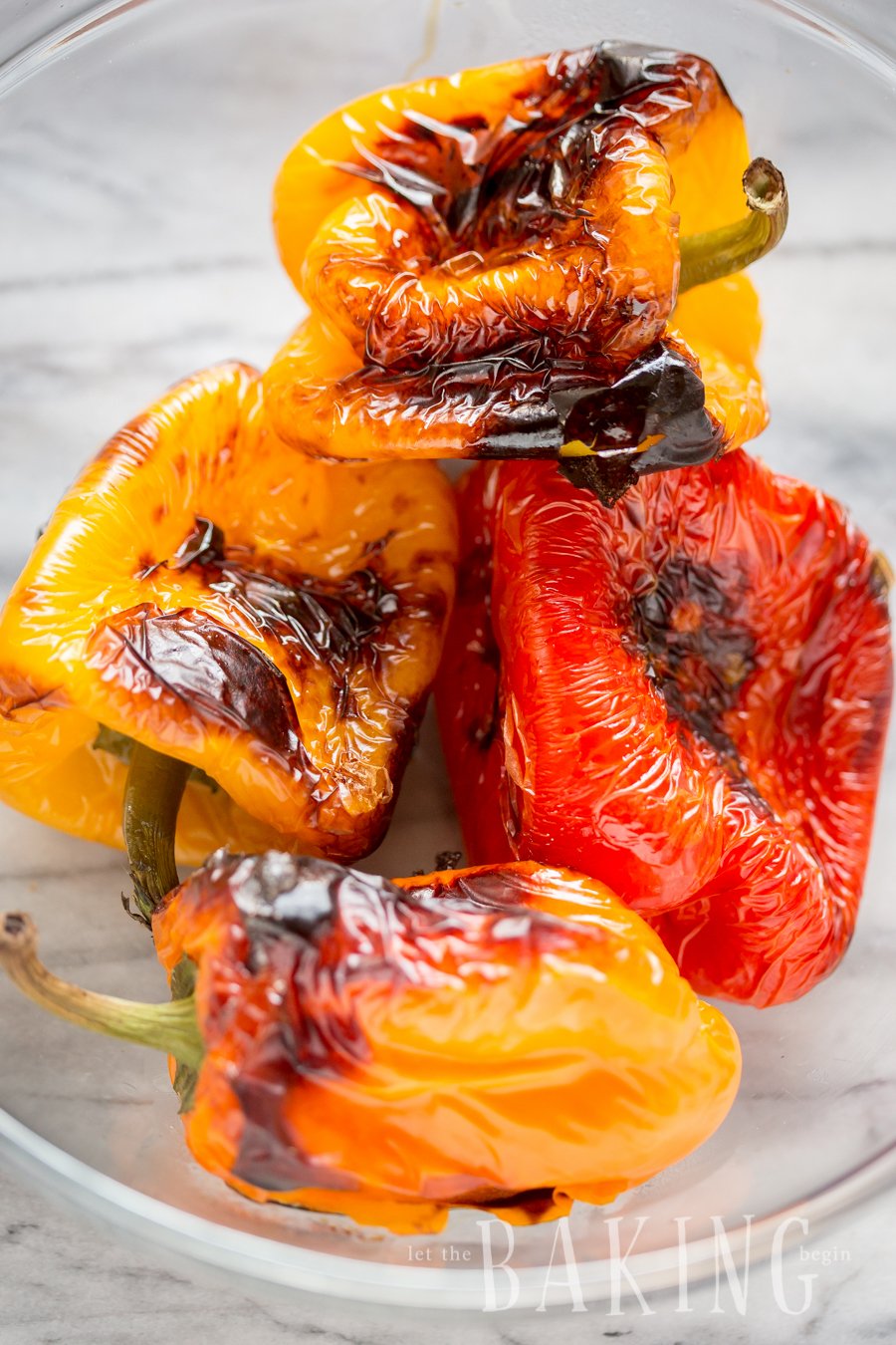 Roasted bell peppers in a glass bowl.