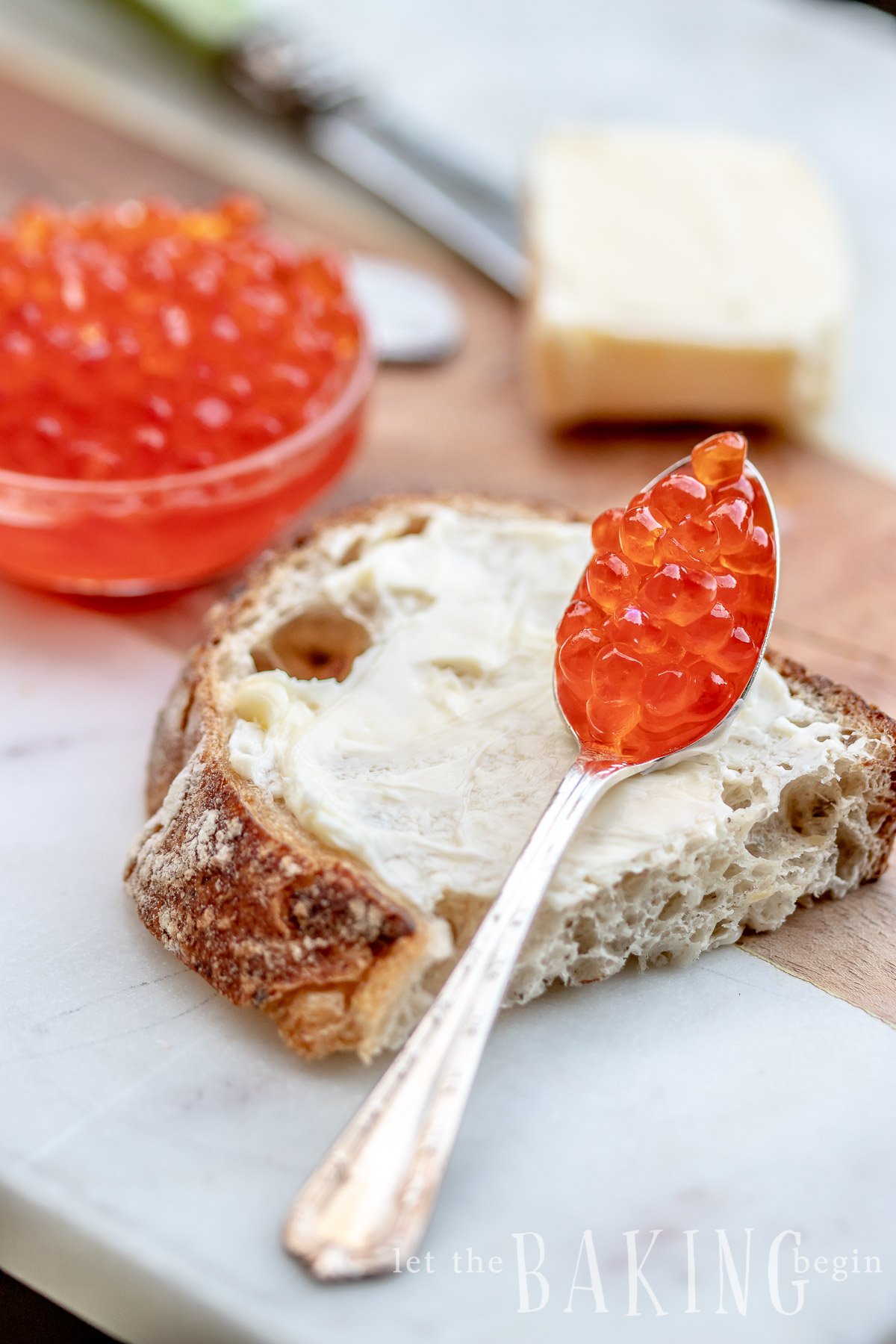 Buttered bread with a spoonful of homemade salmon caviar.