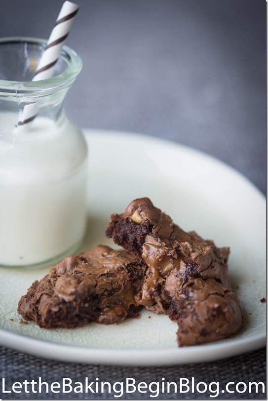 Chocolate brownies with salted caramel and a glass of milk on a plate.