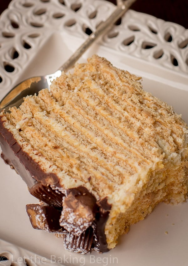 A slice of no bake honey cake on a plate with a spoon.
