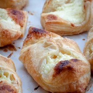 Cheesecake Danish is a puff pastry dessert that's filled with sweet cheesecake filling and drizzled with Lemon Sugar Glaze. Make it once and your family will ask you to make it time and time again. Ready in 30 minutes or less!