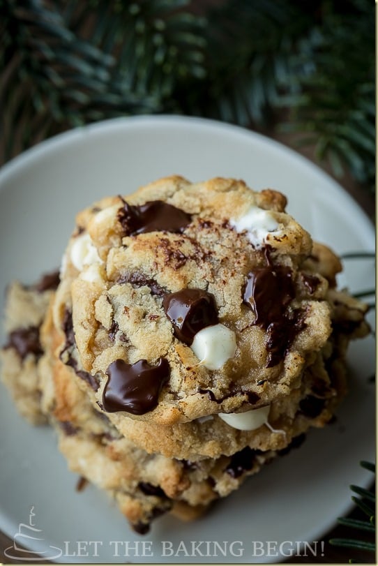 Stack of chocolate chip cookies with white chocolate and dark chocolate on a white plate