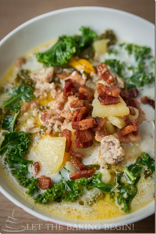 A bowl of hearty zuppa Toscana topped with fresh bacon pieces. 