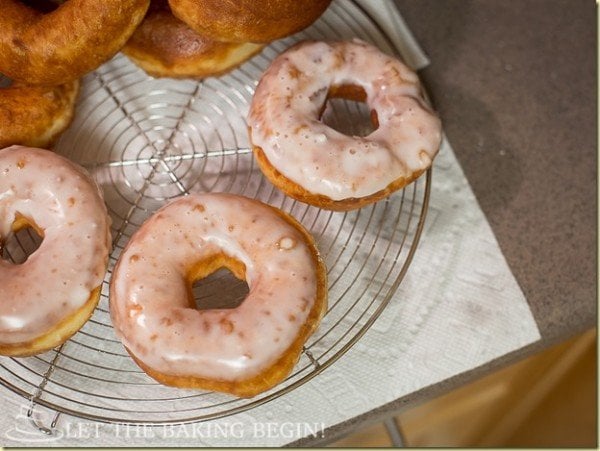 Super soft doughnuts with sugar glaze on a cooling rack. 