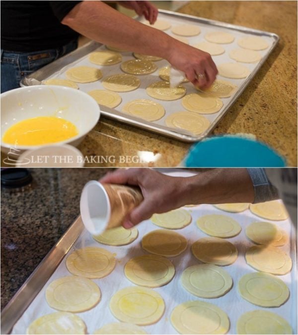 Topping the puff pastries with egg wash and coarse sugar. 