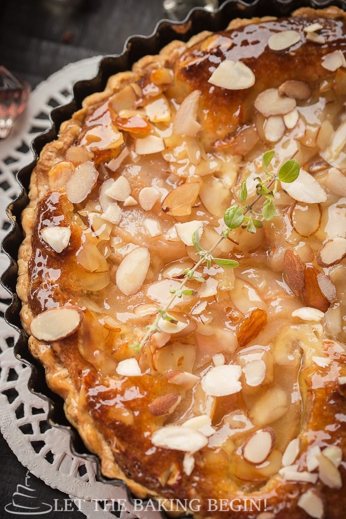 Close up of pear frangipane tart with sliced almonds on top