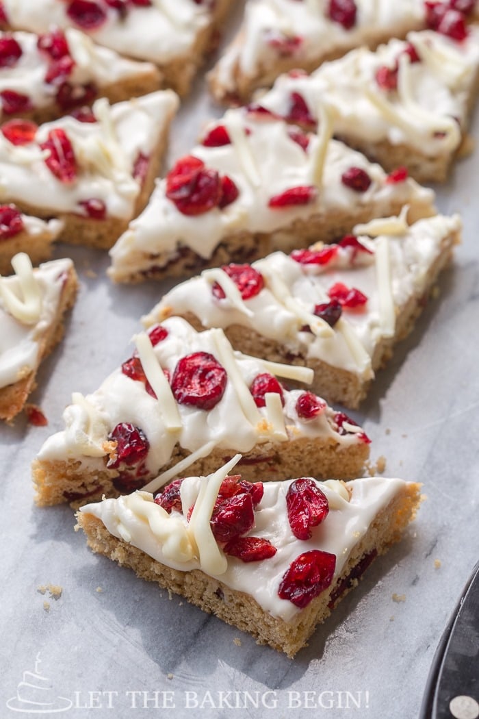 Cranberry bliss bars topped with cranberries and white chocolate.