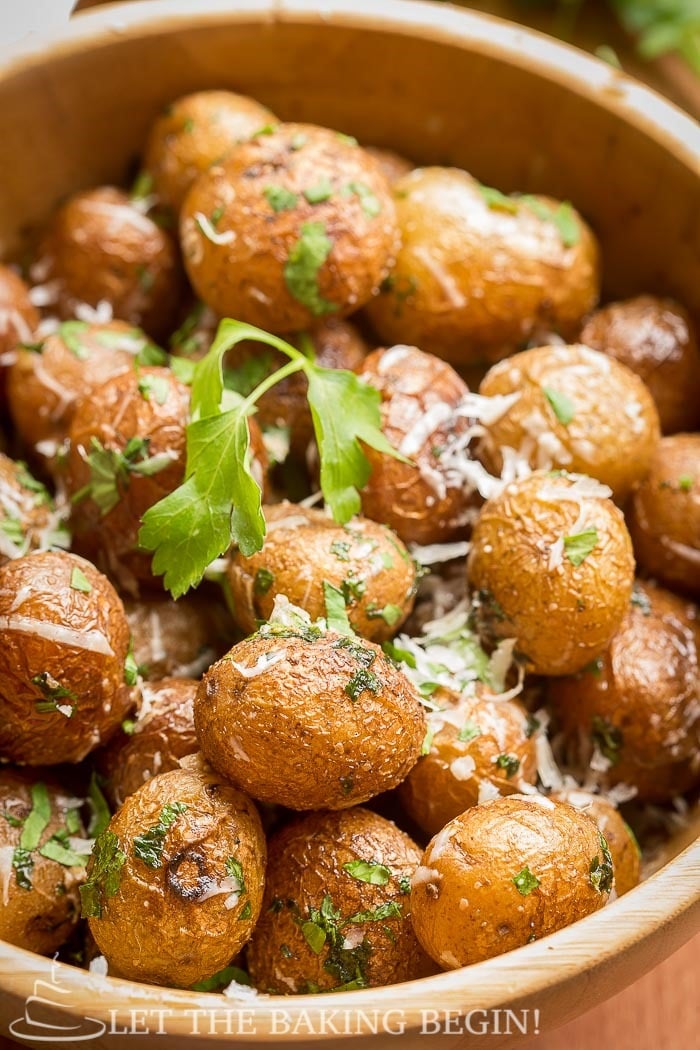 Pan Seared Parmesan Little Potatoes in a bowl topped with cheese and cilantro. 