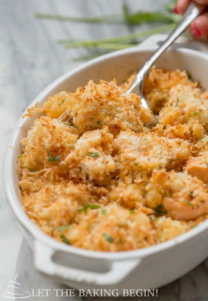 Up close picture of Cheesy Parmesan Crusted Salmon Bake in a casserole dish.