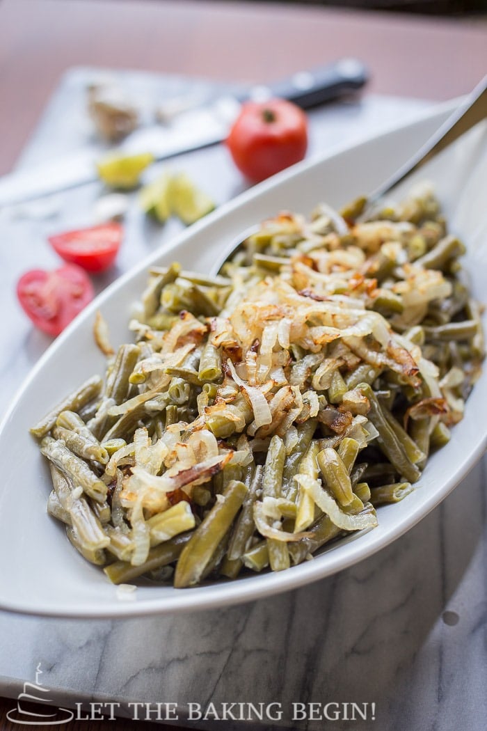Creamy Garlic Parmesan Green Beans with sauteed onions, in a creamy garlic whipping sauce. Delicious green beans recipe. 