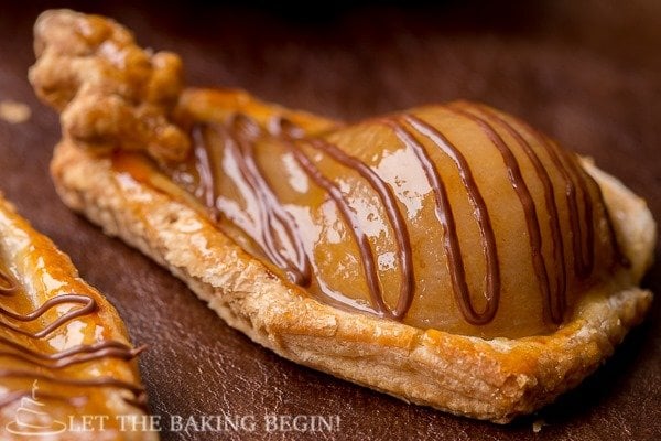 A poached pear in pastry topped with a Nutella drizzle. 