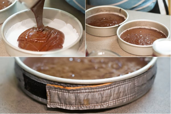 Chocolate batter is divided into two cake forms lined with parchment. Cake strip is placed around the form. 