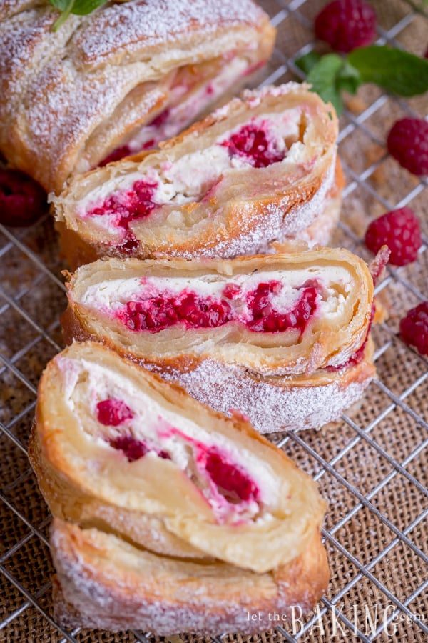Raspberry Cheesecake Danish - Puff pastry braid filled with cheesecake and raspberries is impressive as it is easy to make. Follow the step by step picture instructions for a homemade dessert that take only 30 minutes to make! By Let the Baking Begin!
