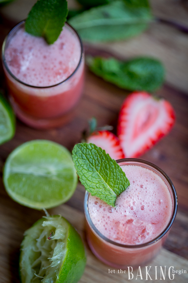Strawberry-Mint Limeade in two glasses with mint leaves and limes.