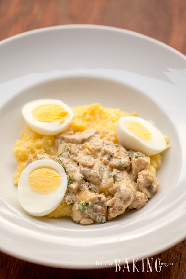 Polenta with eggs and mushrooms in a white bowl.