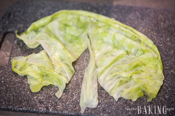 Cutting the stem off the cabbage leaves. 