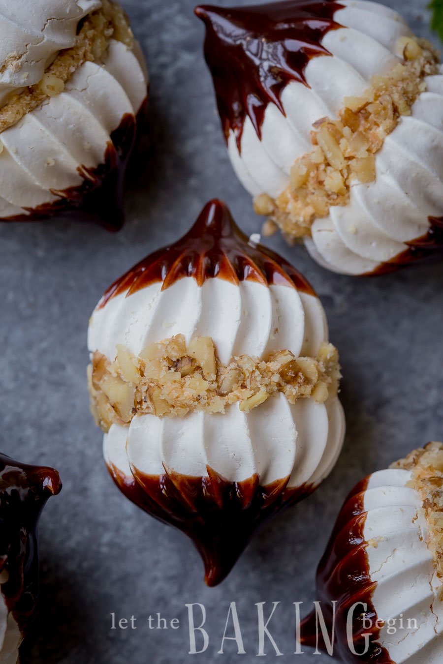 Hazelnut Meringue Bombs covered in chopped hazelnuts and dipped in ganache.