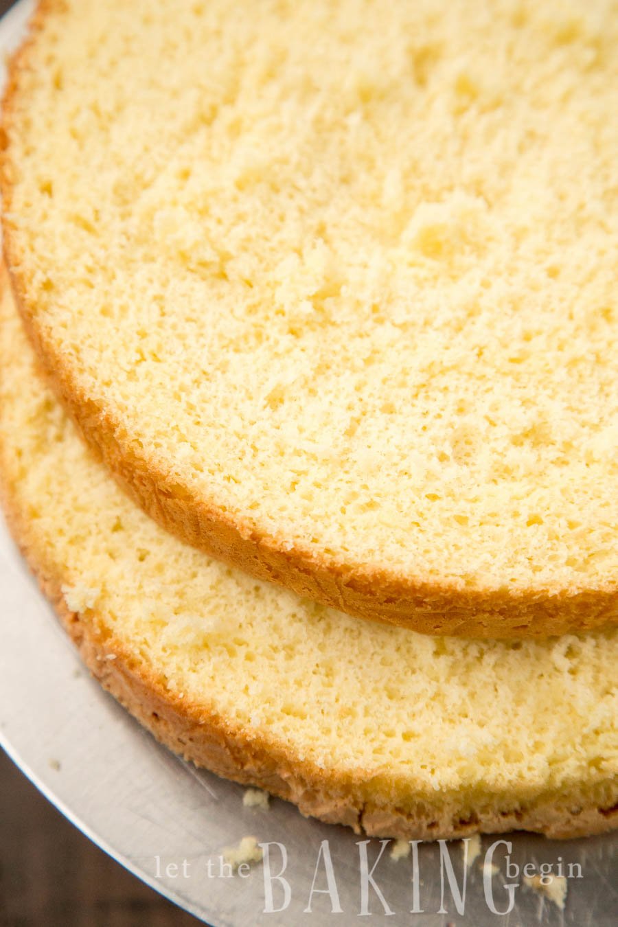 Simple yellow sponge cake, biskvit on a baking sheet cut in half. 