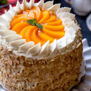 Peaches and Cream Cake Recipe - Easy Dessert made of Soft layers of Sponge Cake with Chunky Peach Preserve and lightly sweetened Whipped Cream. Roasted Almonds add a nice pleasant crunch for a textural contrast. | By Let the Baking Begin!