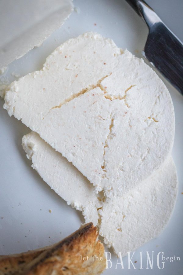 Top view of farmers cheese on a white plate.