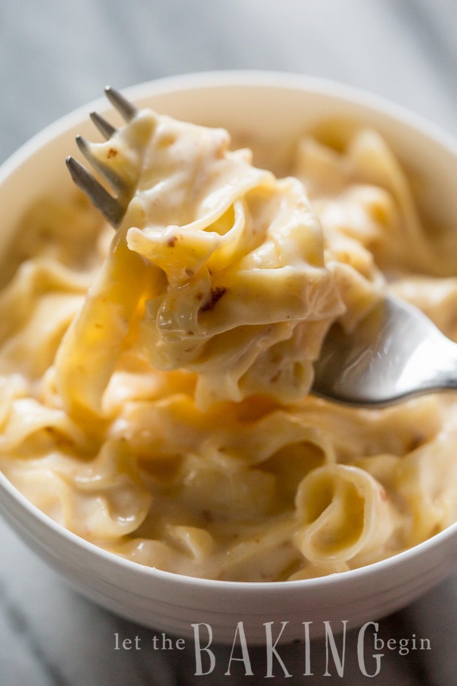 Pasta in Sweet Cream Cheese Sauce in a bowl with a fork full of pasta.