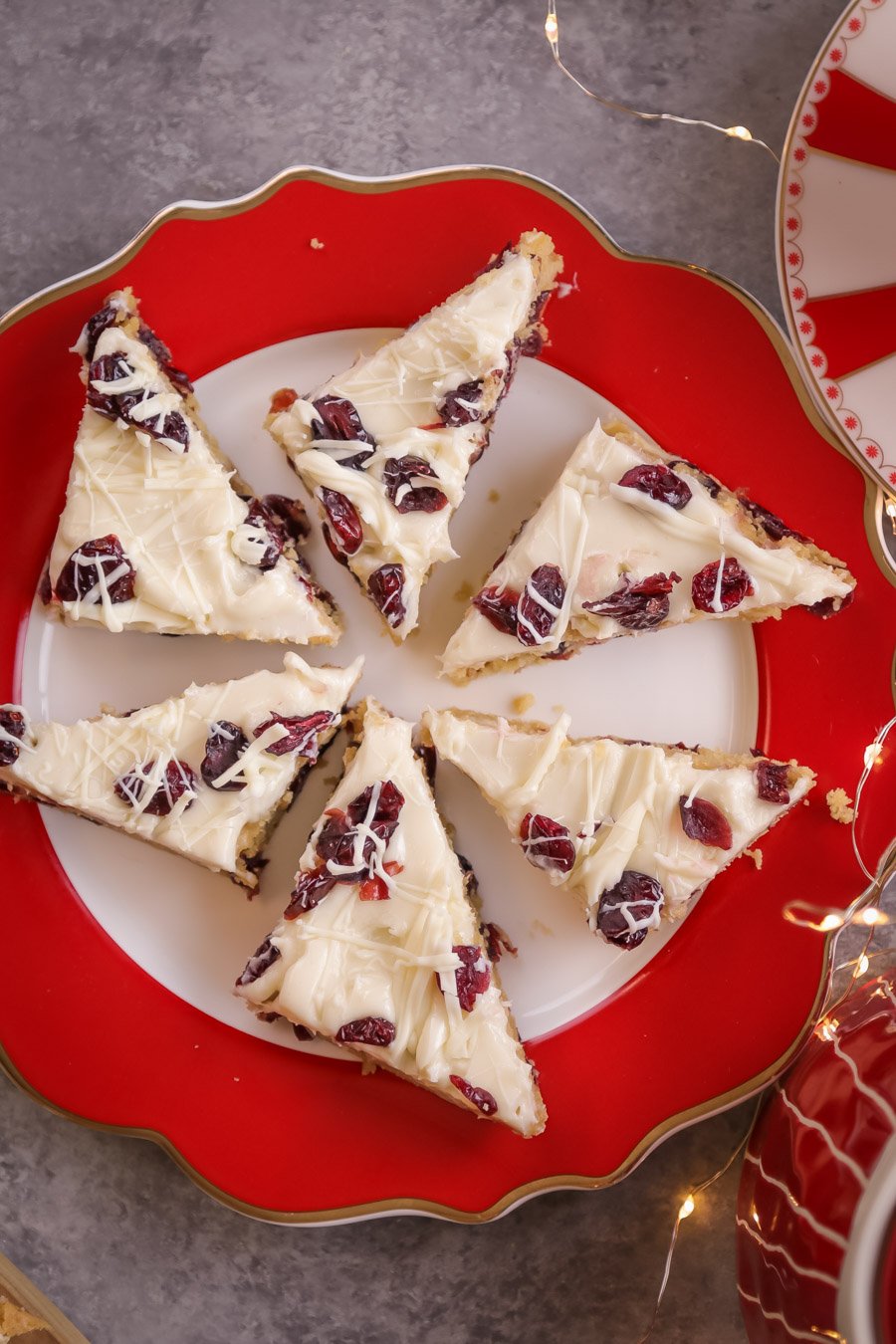 Six Cranberry Bliss Bar on a red and white plate. 