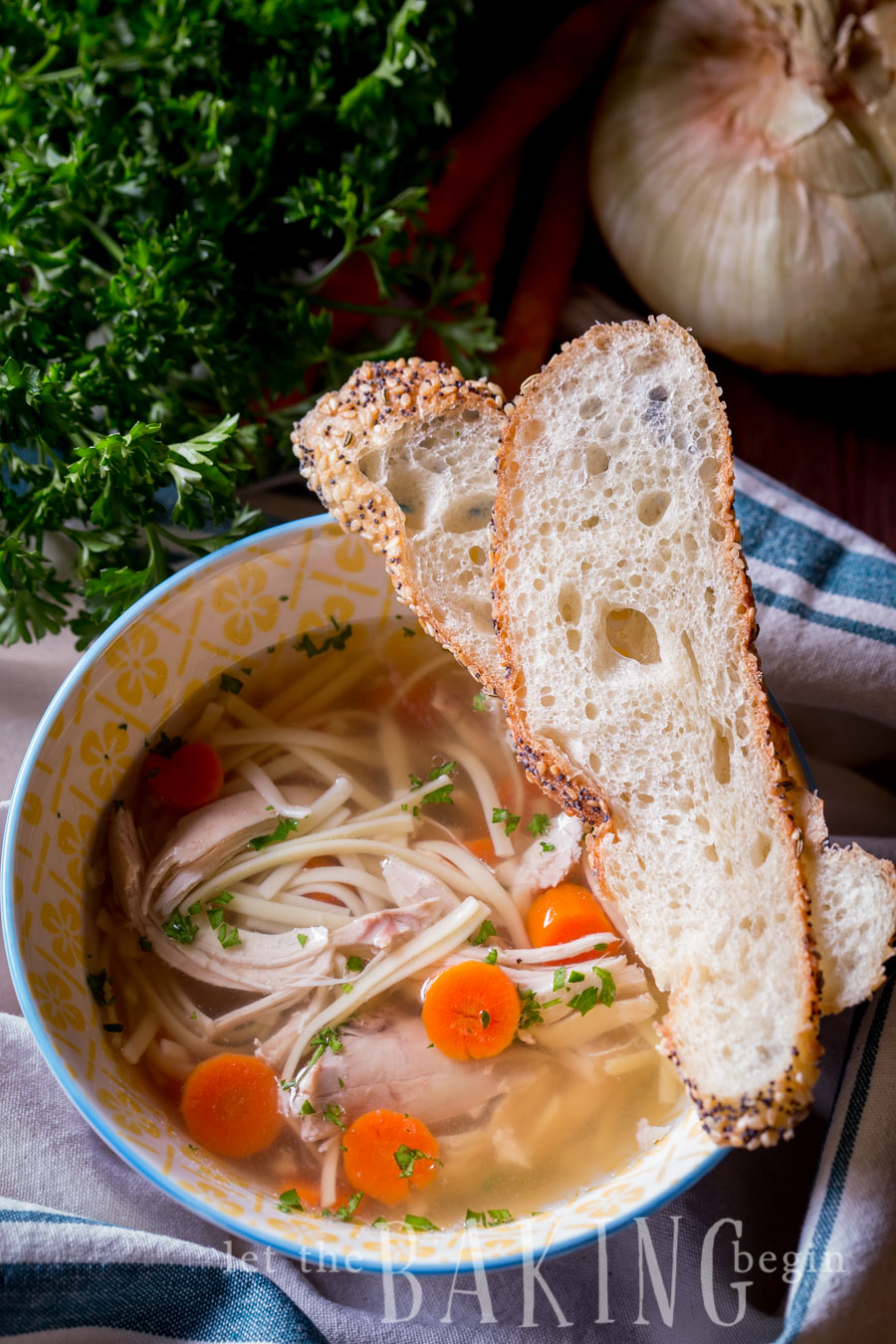 Instant pot chicken noodle soup in a bowl with bread slices. 