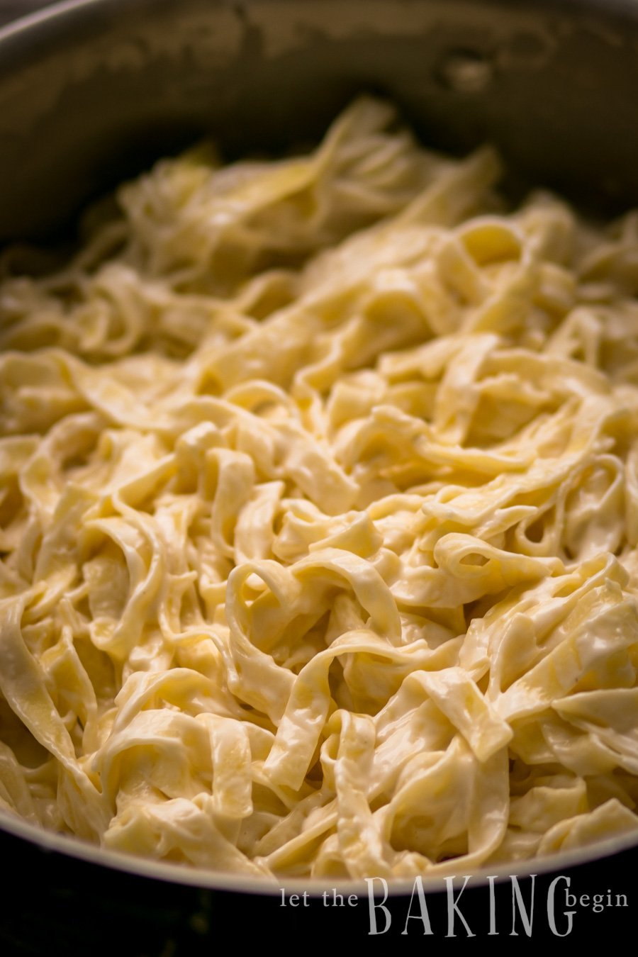 Up close picture of pasta in sweet cream cheese sauce in a pan.