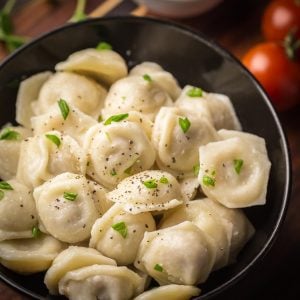 Chicken Pelmeni - tiny dumplings made with soft and easy to make dough, then filled with juicy chicken filling.