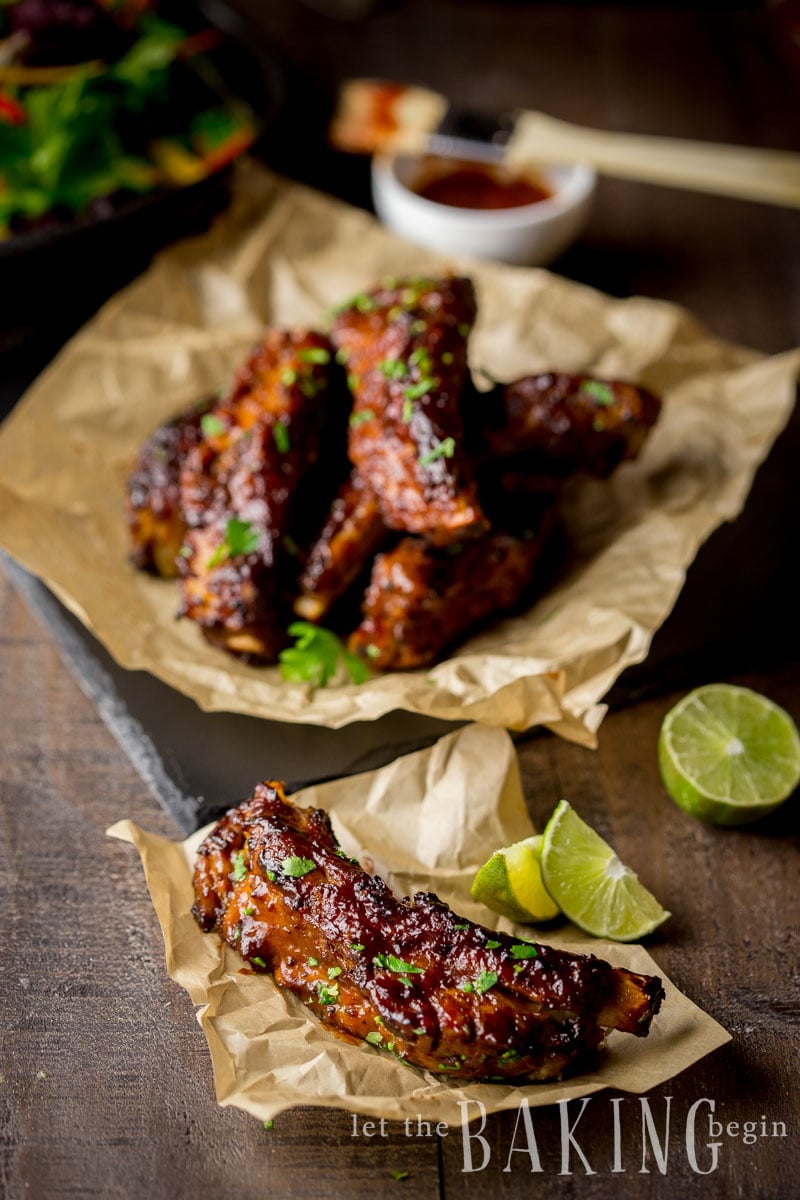 BBQ ribs with lime slices and fresh herbs. 