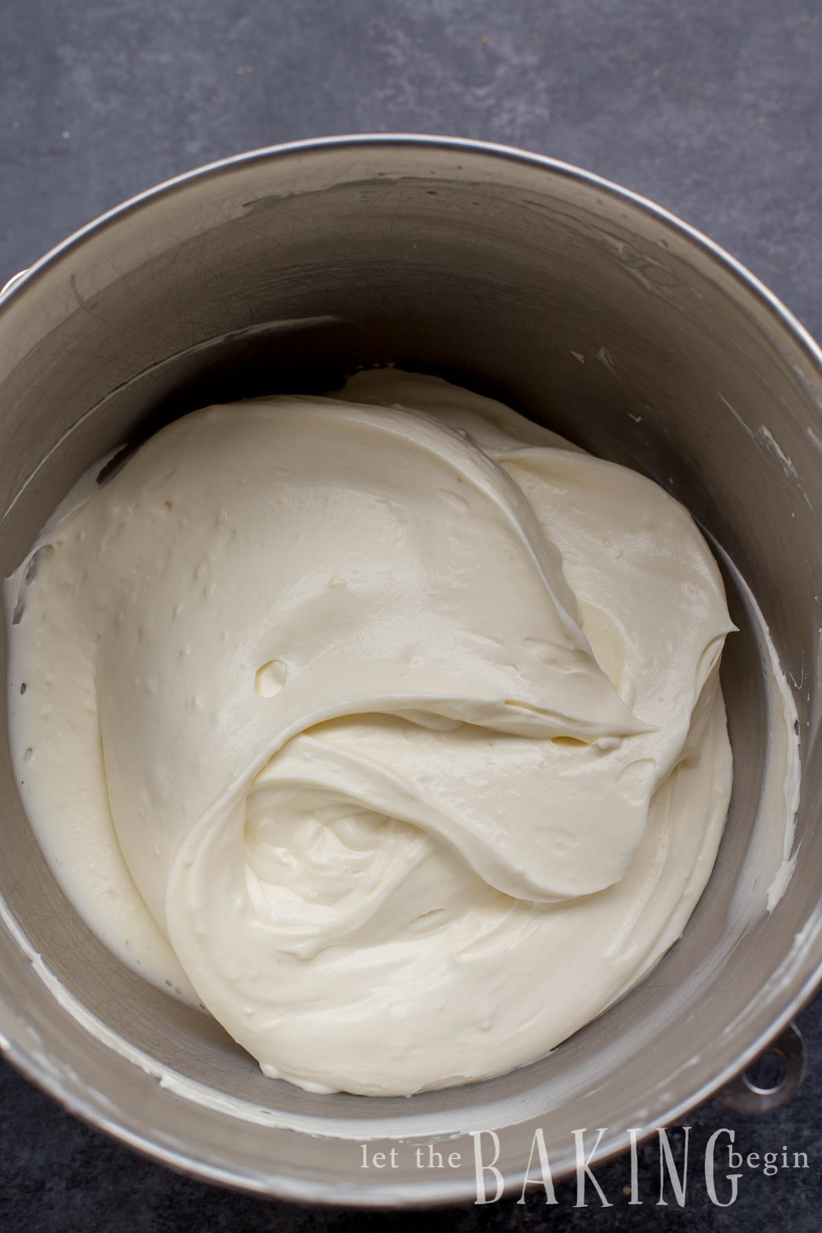 Creamy sour cream frosting in a mixing bowl. 