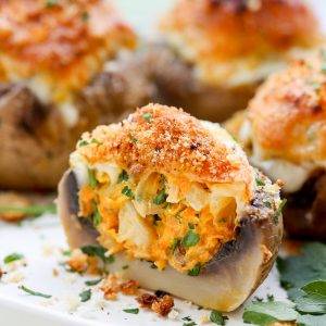 Cheesy Stuffed Mushroom Recipe (Vegetarian) - These are such a hit at parties! The filling of caramelized onions, mushrooms, carrots, garlic and CHEESE come together into the perfect bite!
