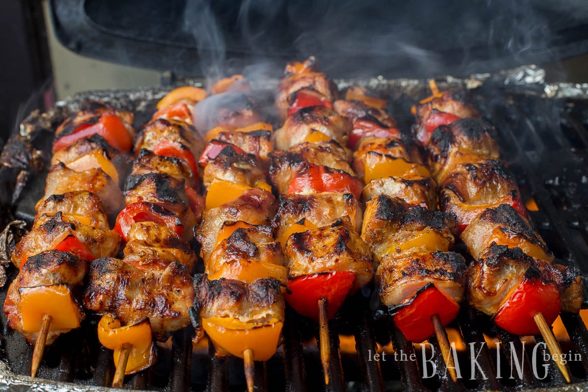 Bacon Wrapped Pork Kabobs - Juicy Kabobs are made even more amazing with the addition of smoky bacon. They're perfect for a summer picnic BBQ. Even you'll be surprised at the amount of flavor packed into these Grilled Kabobs!