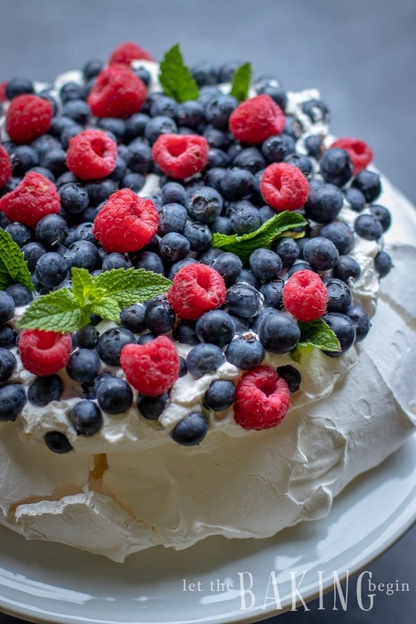 Pavlova Cake is light as air, fluffy as the softest pillow, absolutely delightful meringue dessert that combines, marshmallowy pavlova cake, fluffy whipped cream and berries that come together into a delicious and simple and easy dessert.