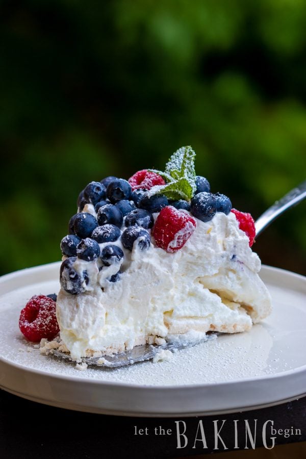 Pavlova Cake is light as air, fluffy as the softest pillow, absolutely delightful meringue dessert that combines, marshmallowy pavlova cake, fluffy whipped cream and berries that come together into a delicious and simple dessert.