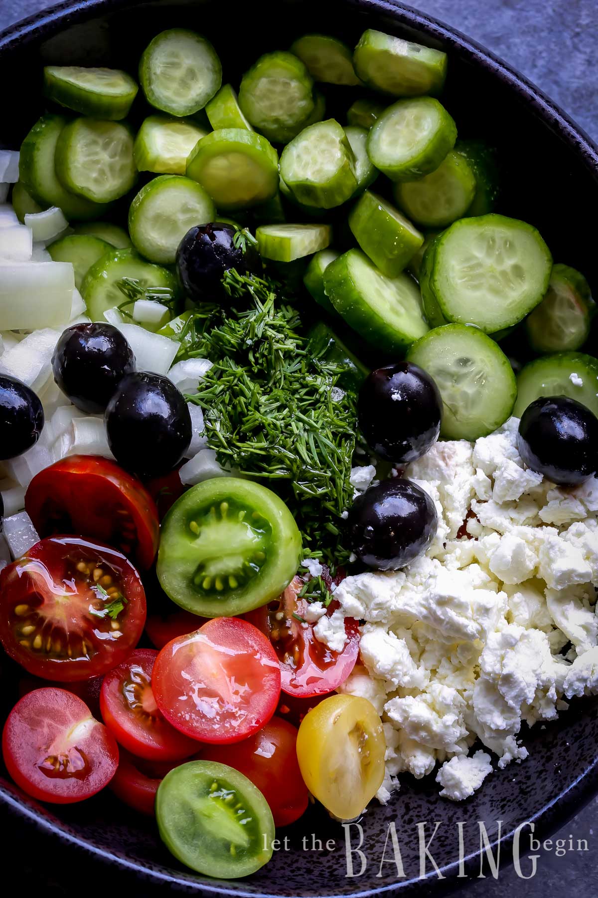 Cucumber salad topped with tomatoes, onions, olives, dill and goat cheese.