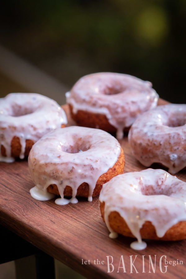 Fried Donuts filled with lots of protein, covered with sugar glaze, placed on a board.