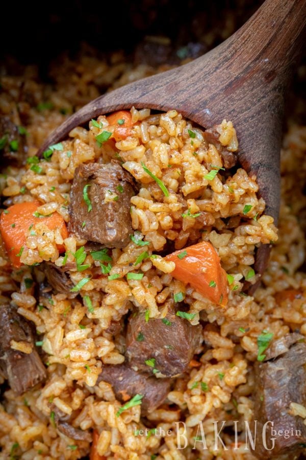 Close up of a spoonful with Beef Rice Plov (rice, beef, carrots).
