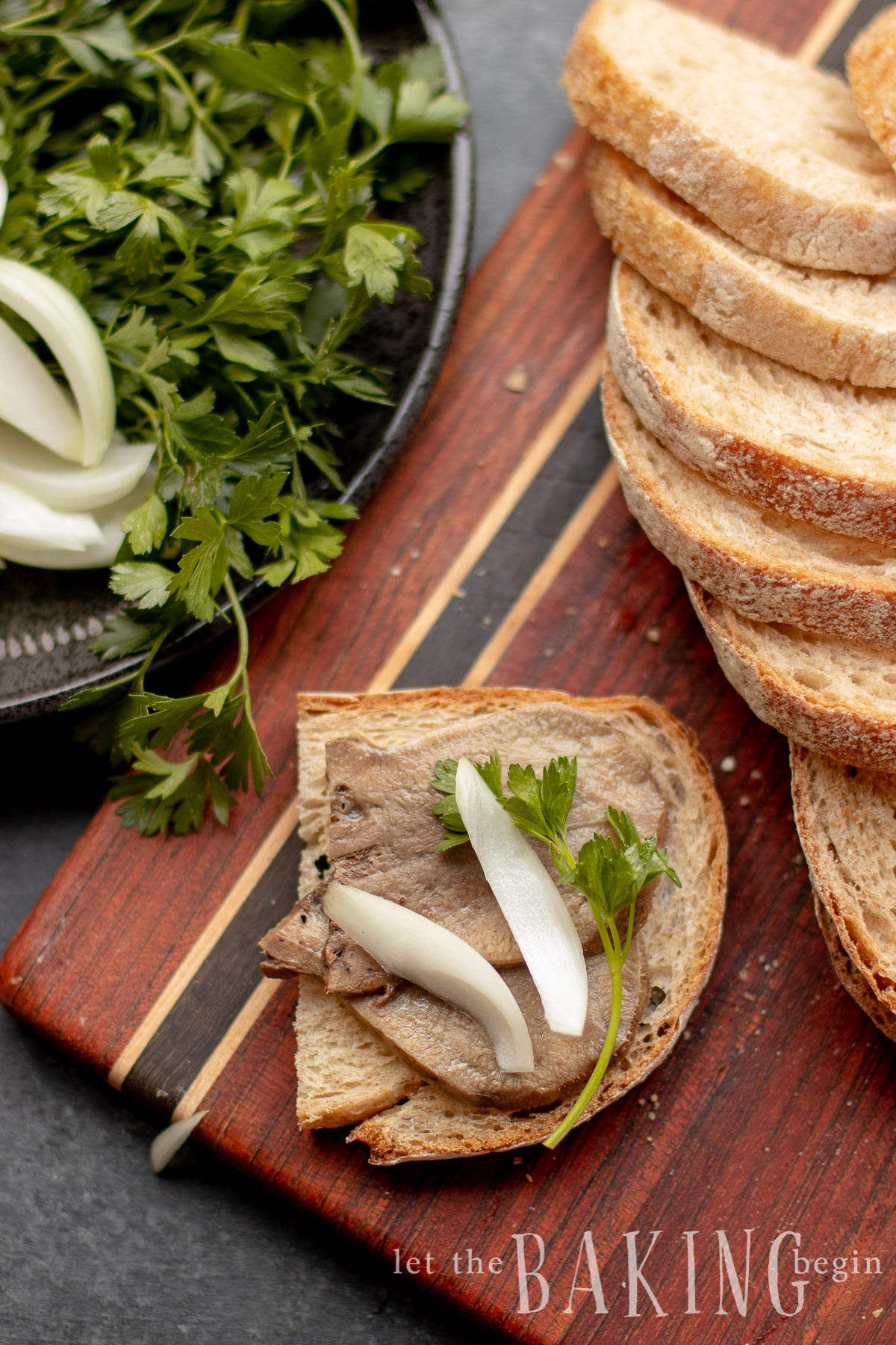 Beef tongue recipe with tongue cooked on top of sliced bread with onion.
