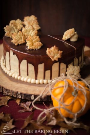 This Moist and Delicious Layered Pumpkin Cake is made with Fluffy Cream Cheese Frosting and a drizzle of Chocolate. The Cream Cheese Frosting has some dulce de leche added, so you know it's extra good! Make this showstopper for Thanksgiving and you'll be the talk of the town, for sure!