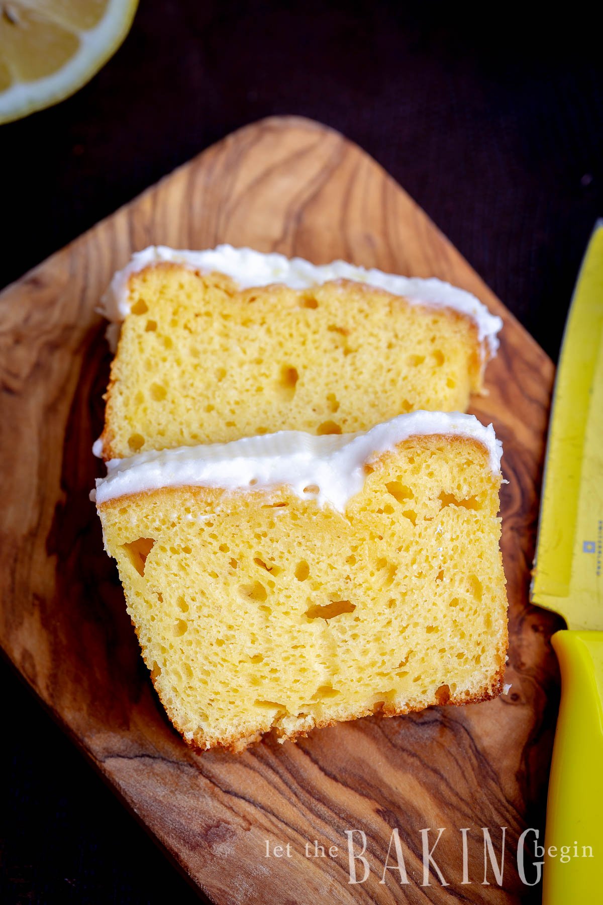 Sliced lemon loaf cake on a cutting board with a yellow knife. 