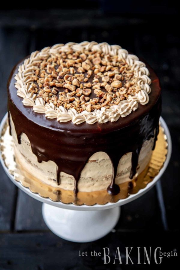 Image of a caramel cake recipe made into a round, chocolate-covered cake. 