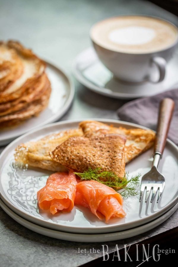 Smoked Salmon served with blinis on a plate.